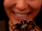 Photo of Cheryl Hayashi holding a spider.