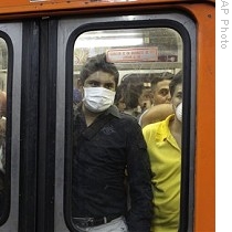 Commuters wear face masks as precaution against swine flu in subway in Mexico City, 29 Apr 2009