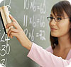 A female teacher
erasing math problems from the chalkboard.