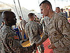 Photo - Chairman of the Joint Chiefs of Staff U.S. Marine Gen. Peter Pace shakes hands with a servicemember in the “Thunder Dome” after a town hall meeting at Camp Lemonier, Djibouti, Aug. 14, 2007.  Defense Dept. photo by U.S. Air Force Staff Sgt. D. Myles Cullen