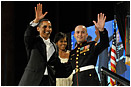 President Barack Obama and U.S. Marine Sgt. Elidio Guillen wave to the crowd at the Commander-in-Chief's Ball in downtown Washington, D.C., Dec. 20, 2009. More than 5,000 men and women in uniform are providing military ceremonial support to the presidential inauguration, a tradition dating back to George Washington's 1789 inauguration. DoD photo by U.S. Air Force Senior Airman Kathrine McDowell