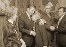 Nancy Reagan and Paul X. Kelley look on as President Reagan consoles a mourner during Memorial Service for servicemen killed and wounded in Lebanon and Grenada held at the Marine Headquarters Building at Camp Lejeune, North Carolina. 11/4/83.