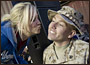 American Idol contestant and country musician Kellie Pickler grants a Christmas wish for a kiss to Marine Corps Sgt. Christopher Lambert at the 2008 USO Holiday Tour stop at Al Asad Air Base, Iraq, Dec. 19, 2008. DoD photo by Navy Petty Officer 1st Class Chad J. McNeeley 