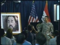 U.S. Army Maj. Gen. William B. Caldwell points to a picture of deceased terrorist Abu Musab al-Zarqawi during a briefing, June 8, 2006.