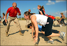 Marine Drill Instructor Sgt. Andrew Lopez provides encouragement to participants during the push-up section of the Boot Camp Challenge at Marine Corps Recruit Depot. U.S. Navy photo by Mass Communication Specialist 1st Class Michael Moriatis [Click for hi-res]