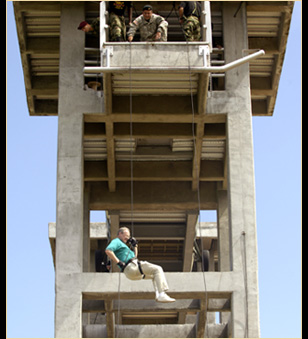 A participant from the 75th Joint Civilian Orientation Conference rappels from a tower during a special forces tactics familiarization course outside Bogota, Colombia, April 22, 2008. 