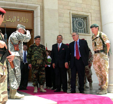 Army Gen. John Abizaid salutes the new Iraqi Defense Minister Abdul Qader following a meeting at the Ministry of Defense. Abizaid, the commander of U.S. Central Command, visited Iraq June 12-13. Photo by Jim Garamone