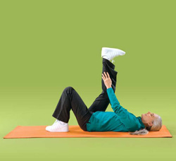 Photo of a woman doing back of leg floor exercises