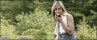 Photo: A woman eating an apple
