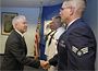 Gates congratulates Air Force Airman First Class David Wood and Navy Petty Officers Reynaldo Aurellano and Jonathon Smith after administering the Ceremonial Oath of Re-enlistment