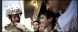 U.S. Navy Adm. Mike Mullen, chairman of the Joint Chiefs of Staff, speaks to children during a visit to Hawijah, Iraq, March 2, 2008.