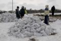 Residents standing next to sand bags in North Dakota