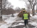 Workers prepare a dike with contstruction equipment in Fargo, North Dakota