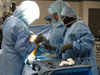 A photograph of a team of surgeons performing surgery