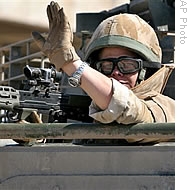 A British army soldier waves from an armored vehicle while on patrol in Basra, southeast of Baghdad, Iraq (File)