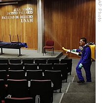 A man sprays disinfectant, as a prevention against the transmission of swine flu, in a classroom at the Mexico's National Autonomous University, in Mexico City, 05 May 2009