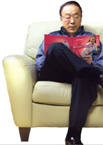 Photo of an elderly Asian man reading the Exercise Guide