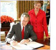 Image of Mrs. Laura Bush with then President George W. Bush at the 2005 proclamation signing.