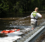 USGS hydrologic technician Erik Ohlson measures the discharge of the Suwannee River floodwaters coming over US highway 90 near Ellaville, Florida. (Saturday, April 11, 2009). - click to enlarge