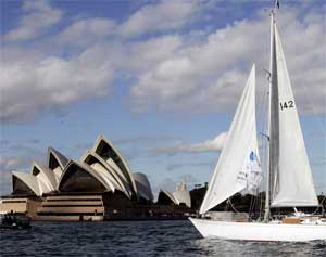 A yacht sails past the Sydney Opera House on Sydney Harbour, Australia, July 13, 2006. [© AP Images]