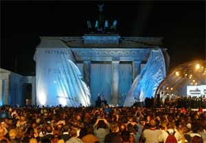 The Brandenburg gate is unwrapped during ceremony in Berlin, Germany, October 3, 2002. [© AP Images]