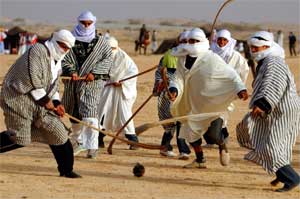 Men play sand hockey during cultural festival in Douz, Tunisia, December 27, 2005. [© AP Images]