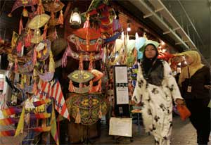 Women walk past a shop selling traditional Malaysian kites, Kuala Lumpur, Malaysia, February 5, 2007. [© AP Images]