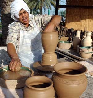 A potter demonstrates his craft during cultural festival, Doha, Qatar, March 23, 2005. [© AP Images]