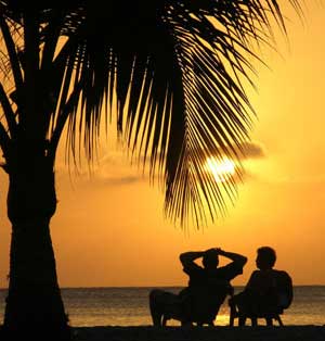 Tourists watch the sunset on a beach in Cartagena, Colombia, February 10, 2006. [© AP Images]