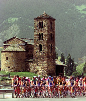 Bikers ride past old church in the Envalira pass between Andorra and southern France, July 16, 1997. [© AP Images]