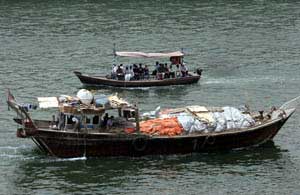 A trading dhow passes a taxi boat on the creek waters in Dubai, United Arab Emirates, May 24, 2007. [© AP Images]