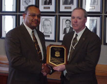 FBI Special Agent Thomas Bailey receives commendation from Sammuel Holland.