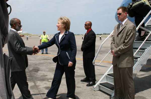 Haitian President Rene Preval (far left) greets Secretary of State Hillary Rodham Clinton (right) upon arrival at the Toussaint Louverture International Airport in Port-au-Prince, Haiti.