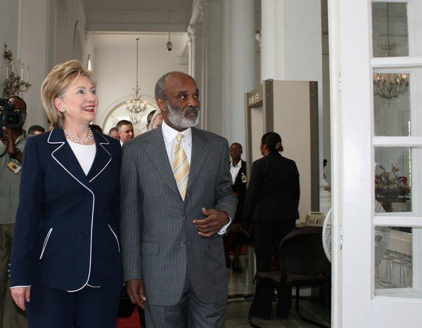 Secretary of State Hillary Rodham Clinton and President of the Republic of Haiti Rene Preval enter the President's private office at the National Palace in Port-au-Prince for a meeting before the press conference.