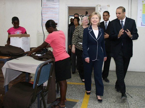 Secretary of State Hillary Rodham Clinton is given a tour by Clifford (to the right beside the Secretary) and Michel Apaid (to the right in the back) at the Inter-American Woven factory in Port-au-Prince. Hope II legislation has created 11,000 jobs in Haiti. Behind Clifford Apaid and the Secretary is  U.S. Ambassador to Haiti Janet A. Sanderson.