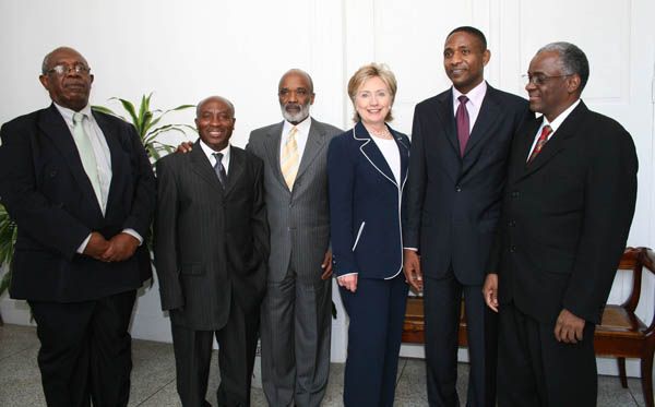 Secretary of State Hillary Rodham Clinton poses with leaders from various political parties in Haiti. From left: Victor Benoit, Fusion des Sociaux Democrates party leader Reverand Chavannes Jeune, Union party leader, President of the Republic of Haiti, Rene Preval Secretary of State Hillary Rodham Clinton Yves Cristallin, Lavalas party leader and Edgard Leblanc, coordinator of the OPL.