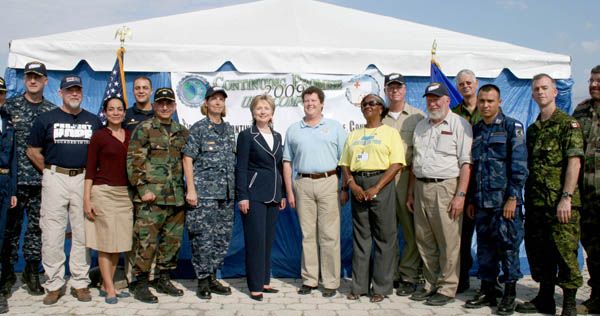 Secretary of State Hillary Rodham Clinton poses with volunteers and medical staff (both military and civilian) outside of the Comfort Clinic in Cite Soleil, Haiti.