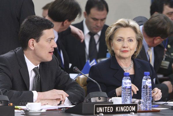U.S. Secretary of State Hillary Rodham Clinton, right, shares a word with British Foreign Secretary David Miliband during a meeting of NATO foreign ministers at NATO headquarters in Brussels, Thursday March 5, 2009. 
