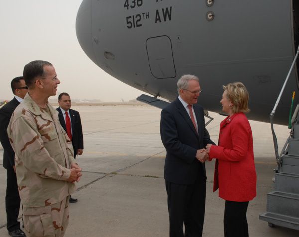 Secretary of State Hillary Rodham Clinton arrives in Baghdad, greeted by newly arrived U.S. Ambassador to Iraq Christopher R. Hill. Admiral Michael Mullen, Chairman of the Joint Chiefs of Staff, looks on left. Photo Credit: Eric W. Brooks, U.S .Embassy Baghdad