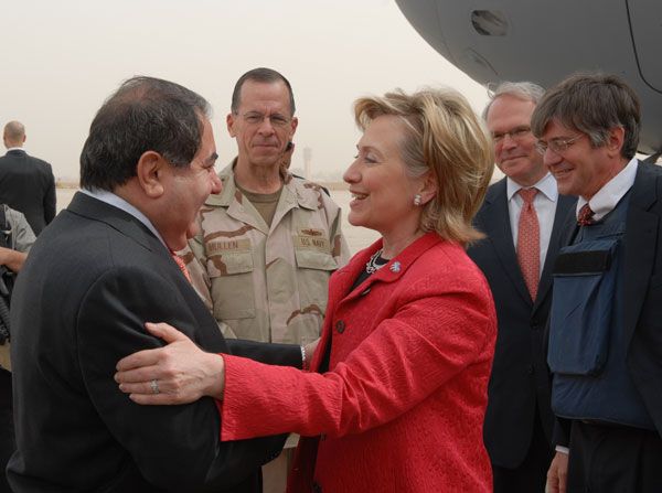 Upon her arrival in Baghdad, U.S. Secretary of State Hillary Rodham Clinton is greeted by newly arrived U.S. Ambassador to Iraq Christopher R. Hill, Chairman of the Joint Chiefs of Staff Admiral Michael Mullen, and Iraqs Minister of Foreign Affairs Hoshyar Zebari.  Deputy Secretary James Steinberg [to the far right] looks on.