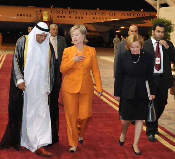 Secretary of State Hillary Rodham Clinton arrives in Kuwait on April 24, 2009 to a welcome from Ambassador Deborah K. Jones [right] and Kuwaiti MFA Ambassador Ali Al-Sammak [left].