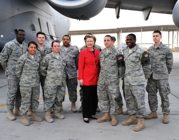 Secretary of State Hillary Rodham Clinton poses with members of the Office of Military Cooperation - Kuwait prior to boarding the plane from Kuwait to Iraq on April 25, 2009.
