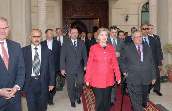 Secretary Clinton is accompanied by Iraqi President Jalal Talabani as they exit Dar As-Salam Palace after their meeting, Baghdad, Iraq.