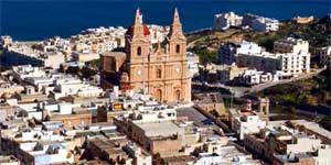 Aerial view of Mellieha village with its parish church, Malta. August 25, 2003. [© AP Images]
