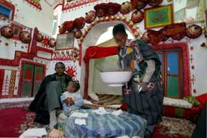 A boy cleans up in a traditionally decorated home in Ghadamis, Libya, February 2, 2004. [© AP Images]