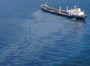 Ship with oil leaking onto water surface.