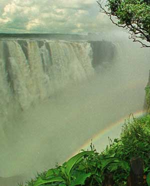 Rainbow forms over water at Victoria Falls, Zimbabwe, March 23, 1997. [© AP Images]