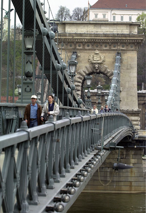 Visitors walk across the Danube River's Chain Bridge in Budapest, Hungary, April 5, 2004. [© AP Images]
