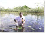photo of scientist collecting a water sample