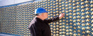 Man touching the stars at the World War II memorial.